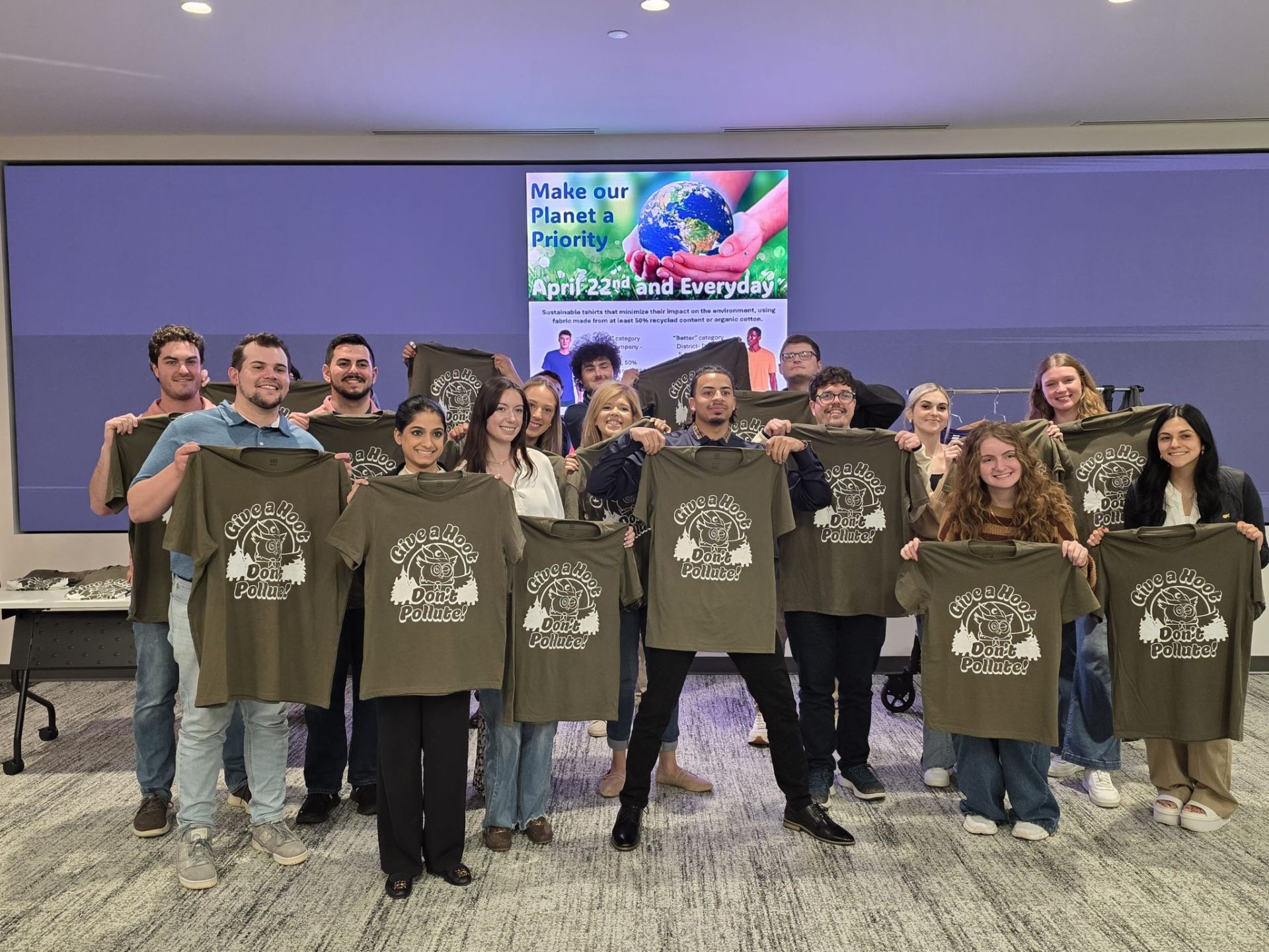 Club Colors team members holding a completed run of branded apparel